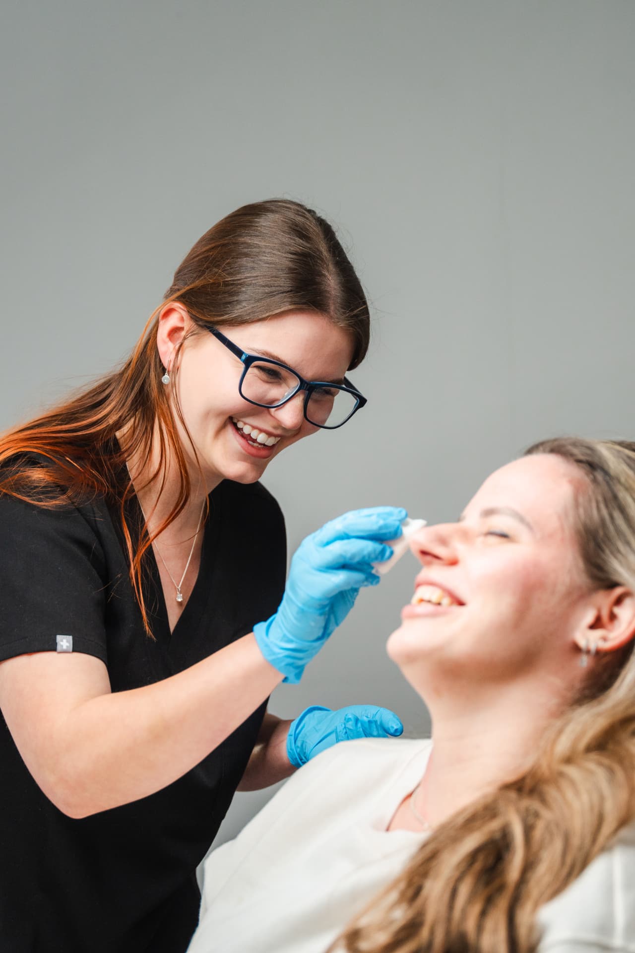 An Oriah practitioner caring for a laughing client
